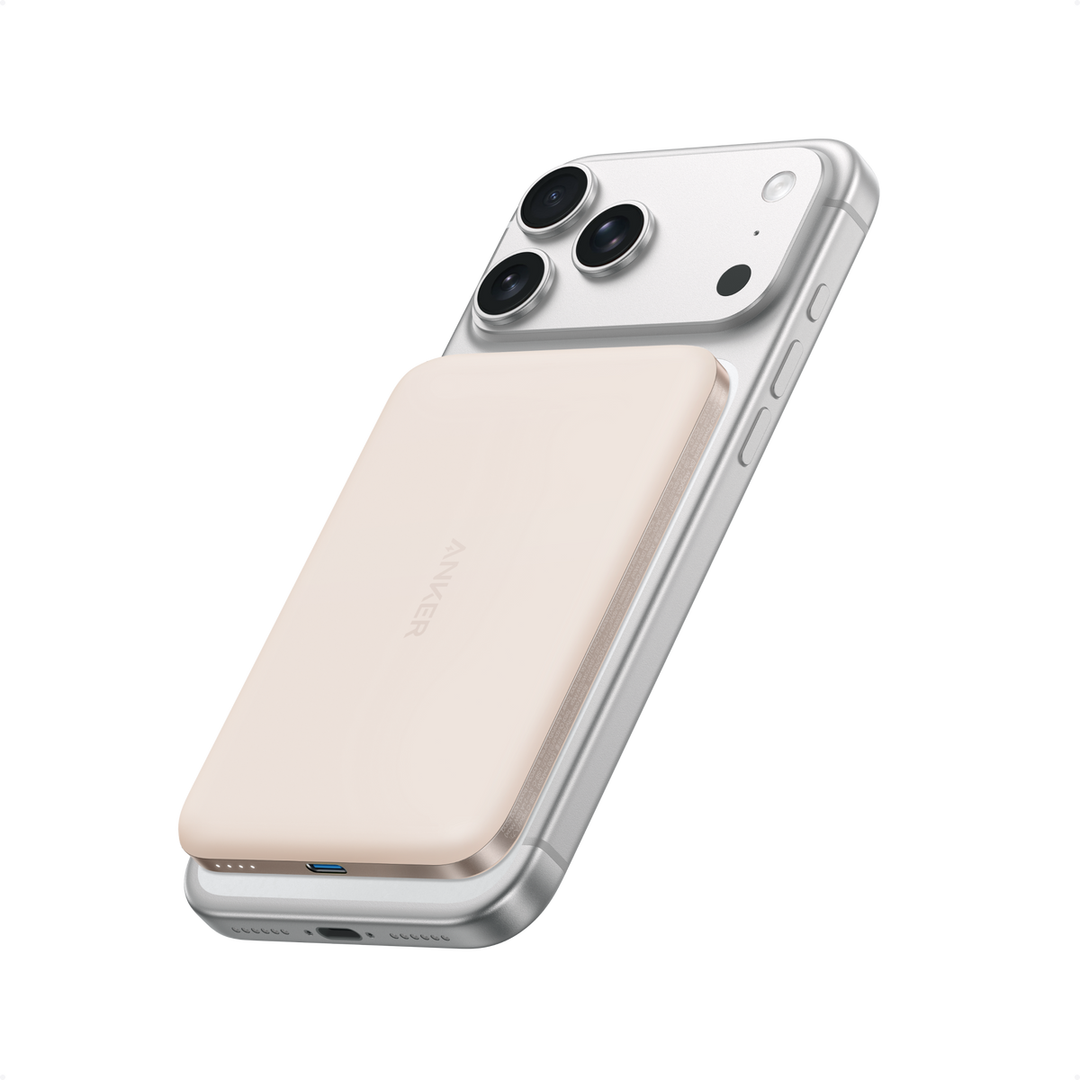 Beige Anker Nano MagGo 5K power bank attached to the back of an iPhone.