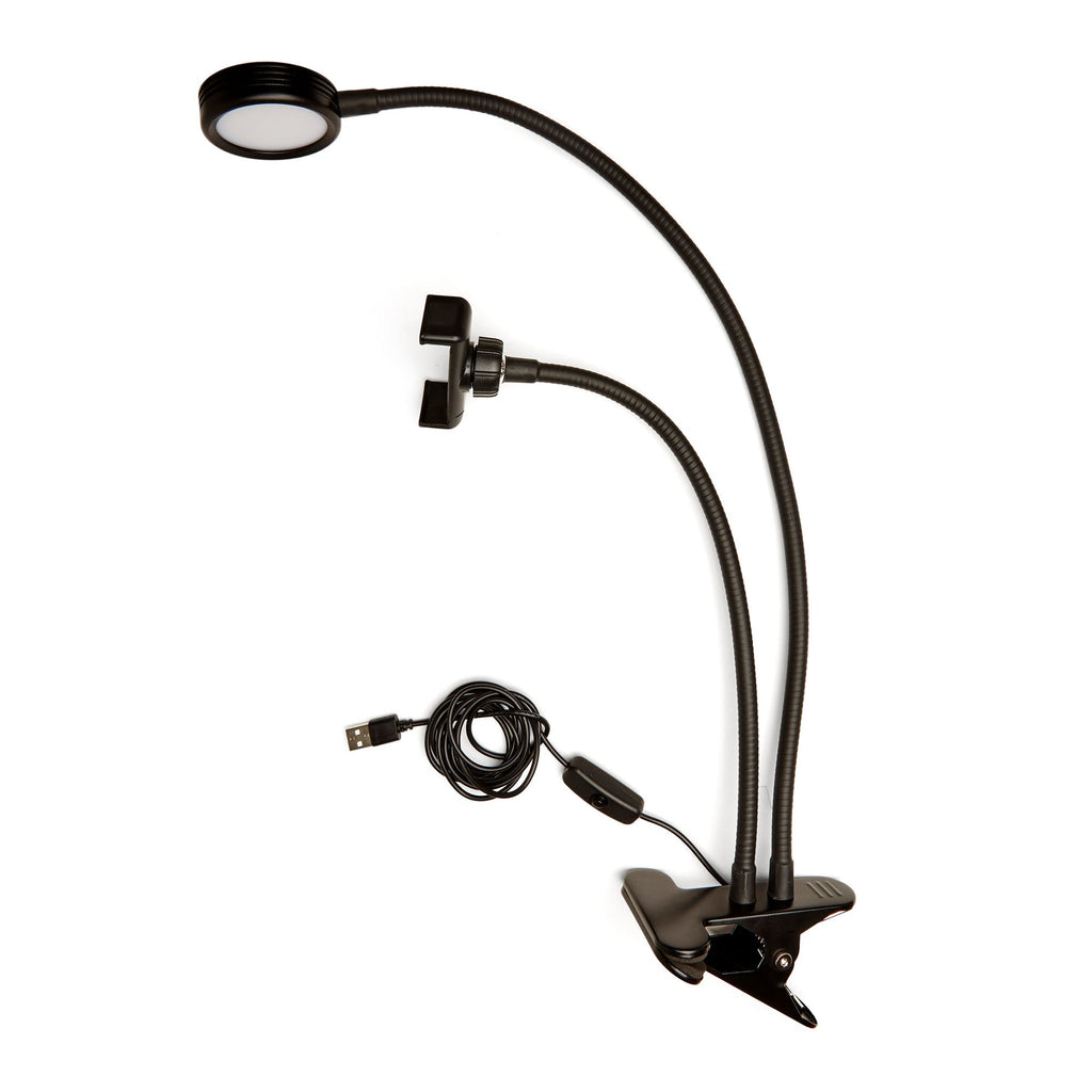 Black live streaming kit with flexible LED light and phone holder arms, desk clamp, and USB cable.